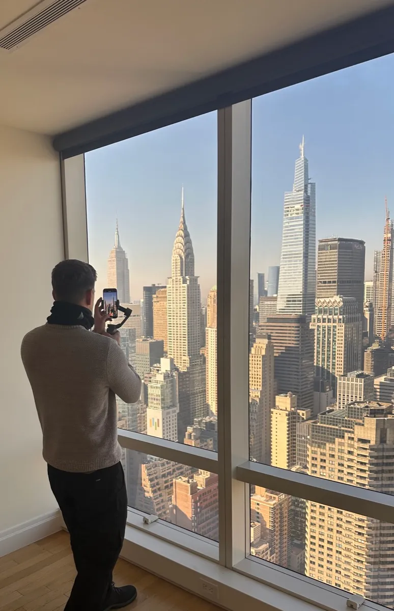 David Finlay photographing the Manhattan skyline from a listing