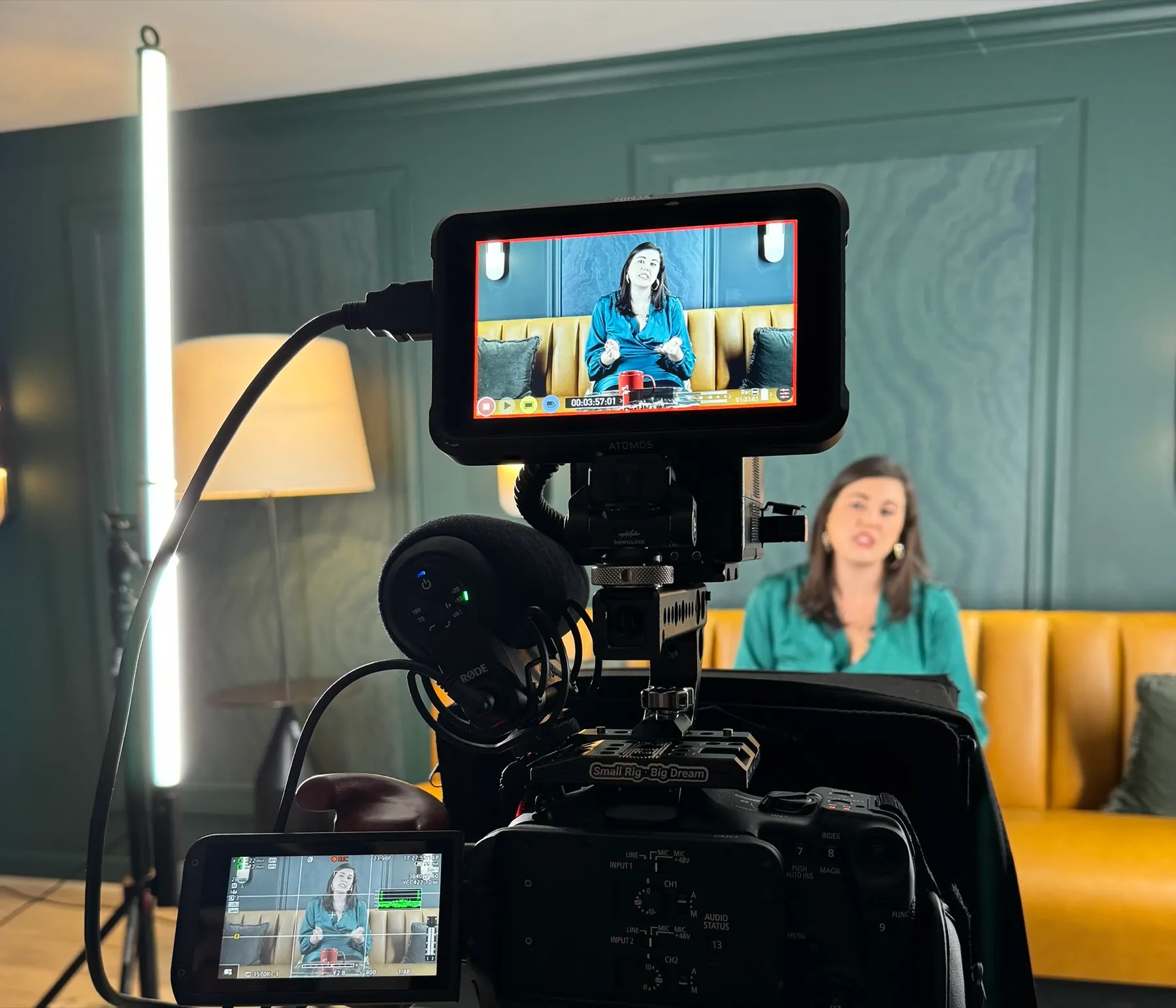 A Finlay Films branding content shoot: a cinema camera and monitor in sharp focus, the agent on camera behind